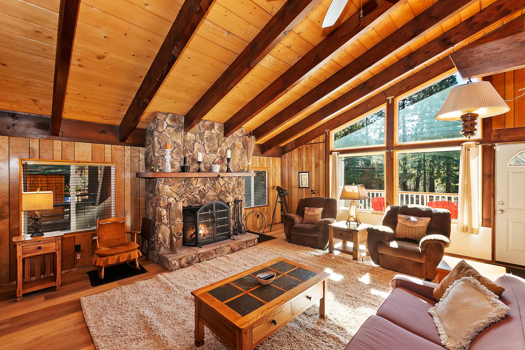 Living room with stone fireplace at Bear View Escape in Big Bear Lake