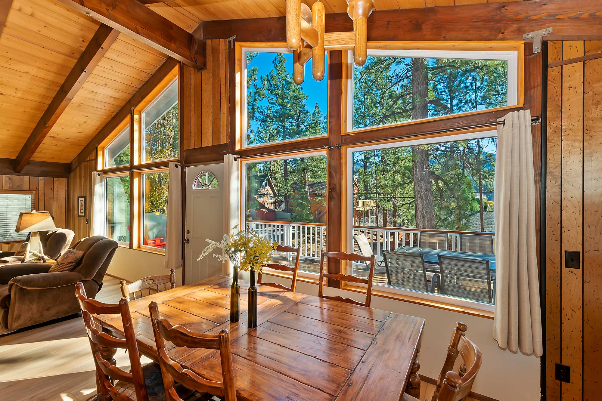 Dining area with large windows and mountain and forest views at Bear View Escape in Big Bear Lake